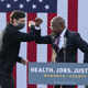 Georgia Democratic Senate candidates Raphael Warnock (R) and Jon Ossoff (L) bump elbows during a "It's Time to Vote" drive-in rally on December 28, 2020 in Stonecrest, Georgia.